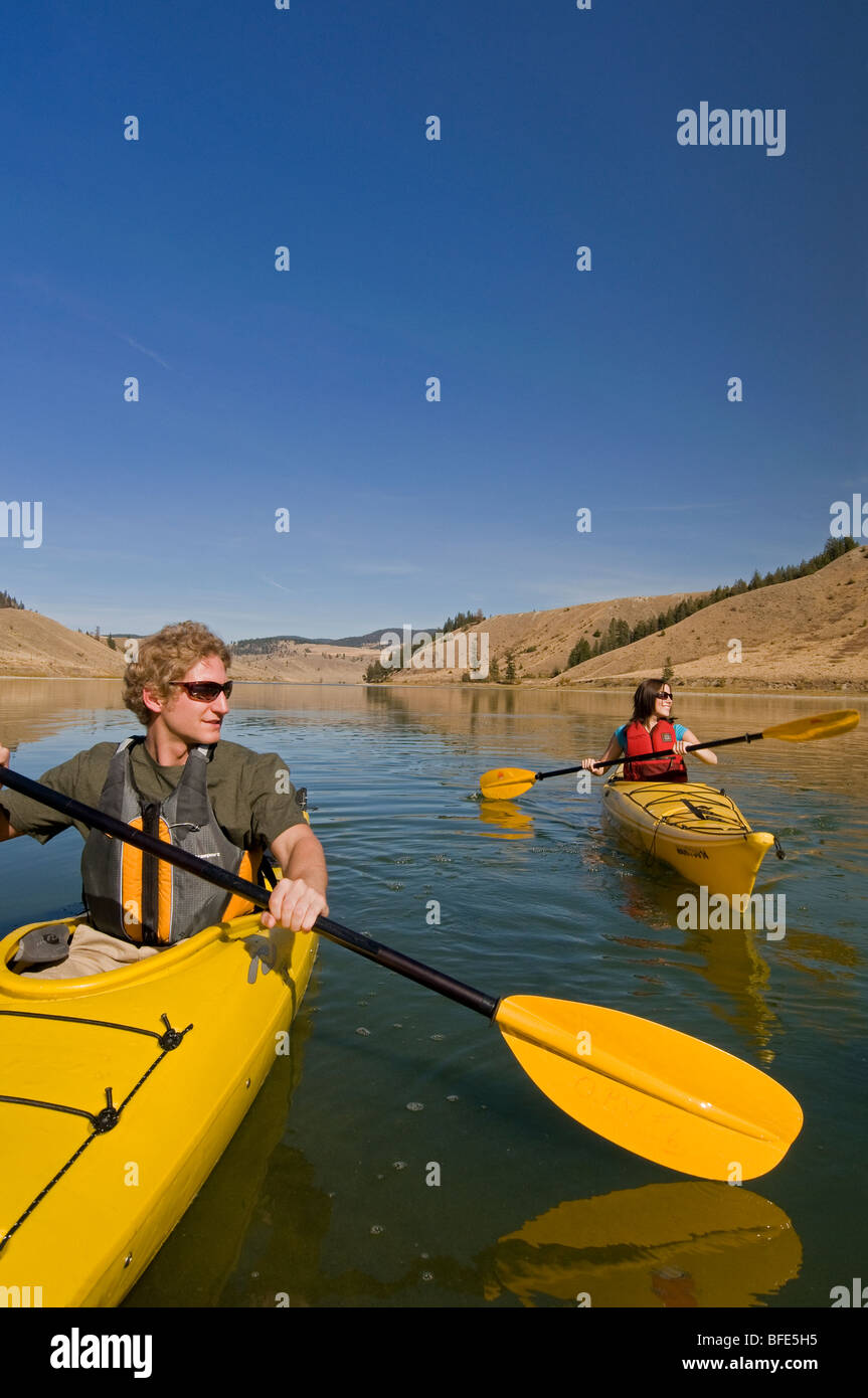 A young couple enjoys a spectacular day of kayaking on Trapp Lake, just