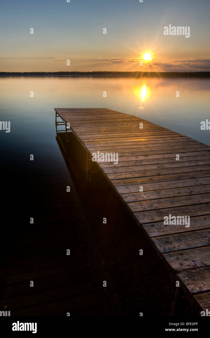 Sunset over a wooden wharf at Lake Audy, Riding Mountain National Park, Manitoba, Canada Stock Photo
