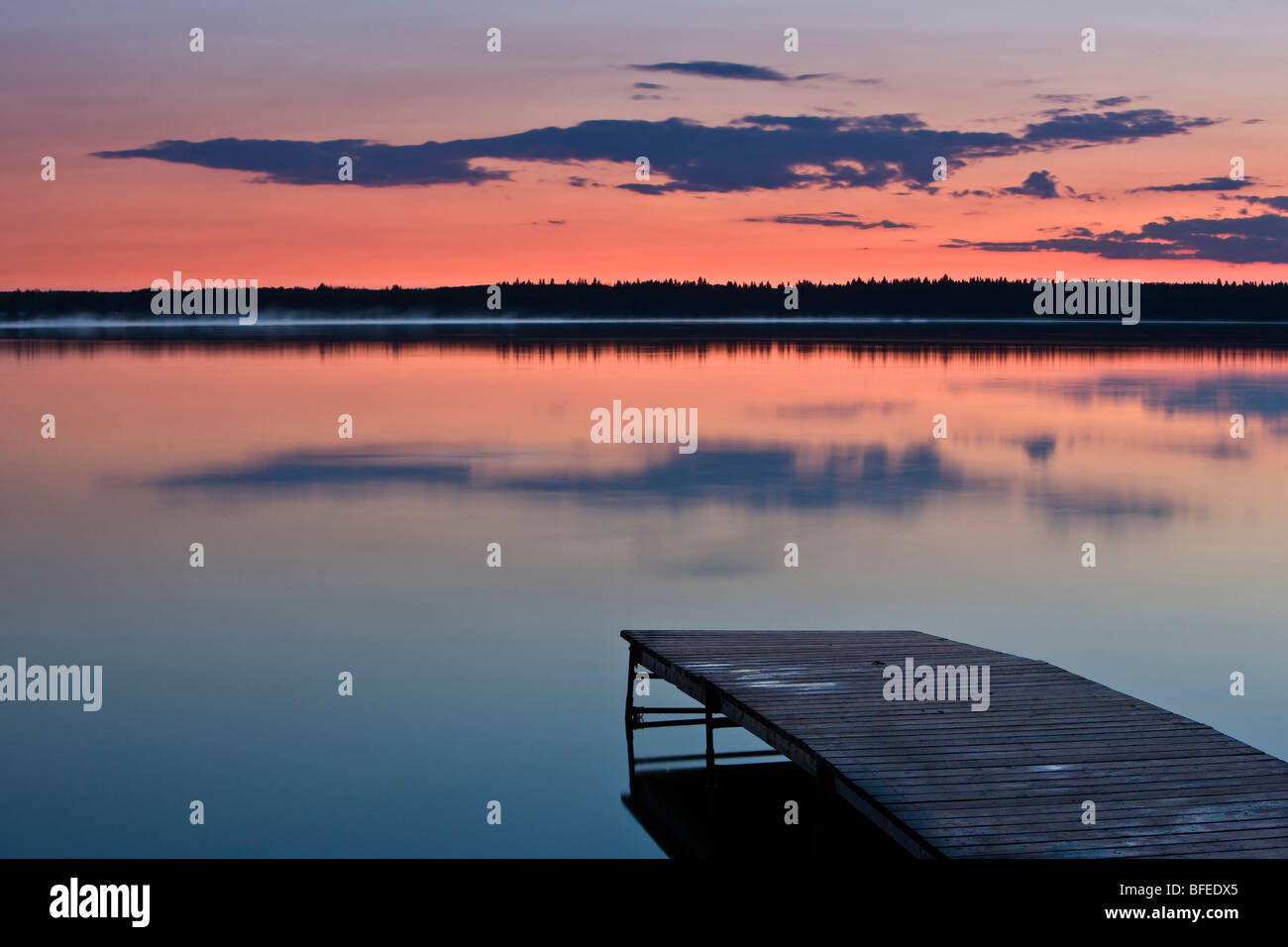 Sunset over a wooden wharf on Lake Audy, Riding Mountain National Park, Manitoba, Canada Stock Photo