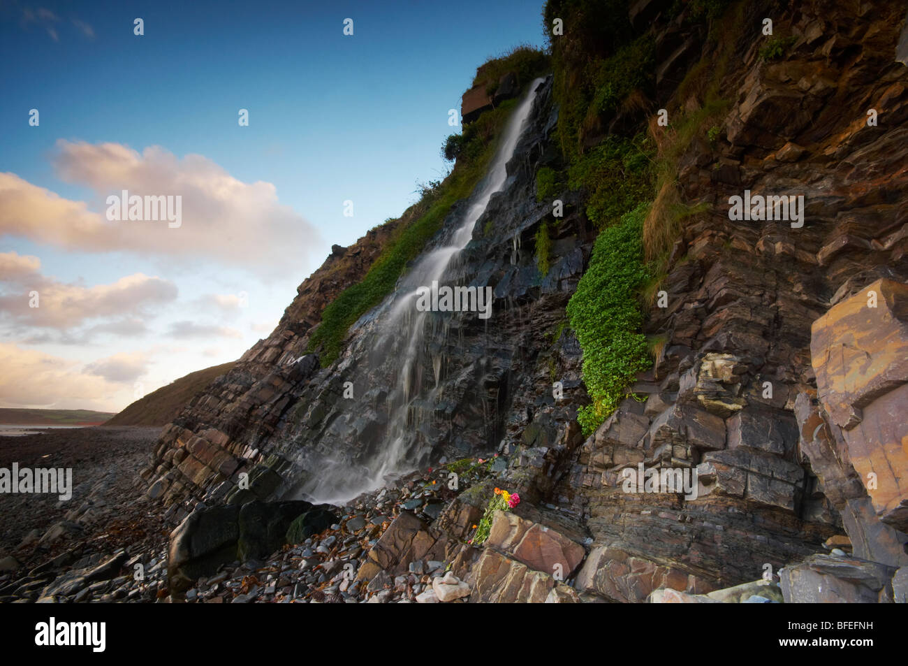 Bucks Mills waterfall cascading down over the beach on the North Devon coast UK Stock Photo