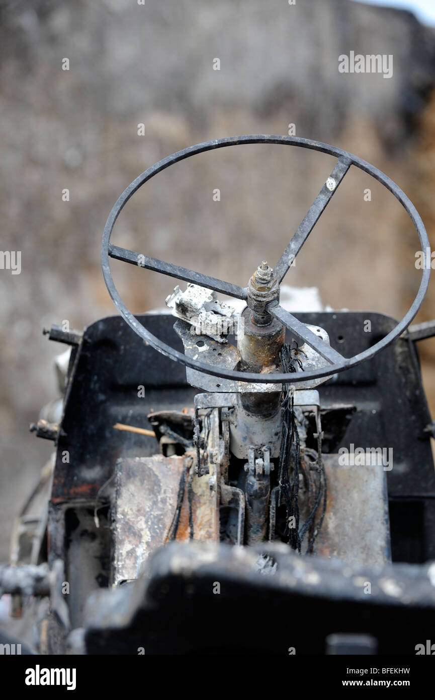 A fire damaged tractor after straw fire in storage area on an East