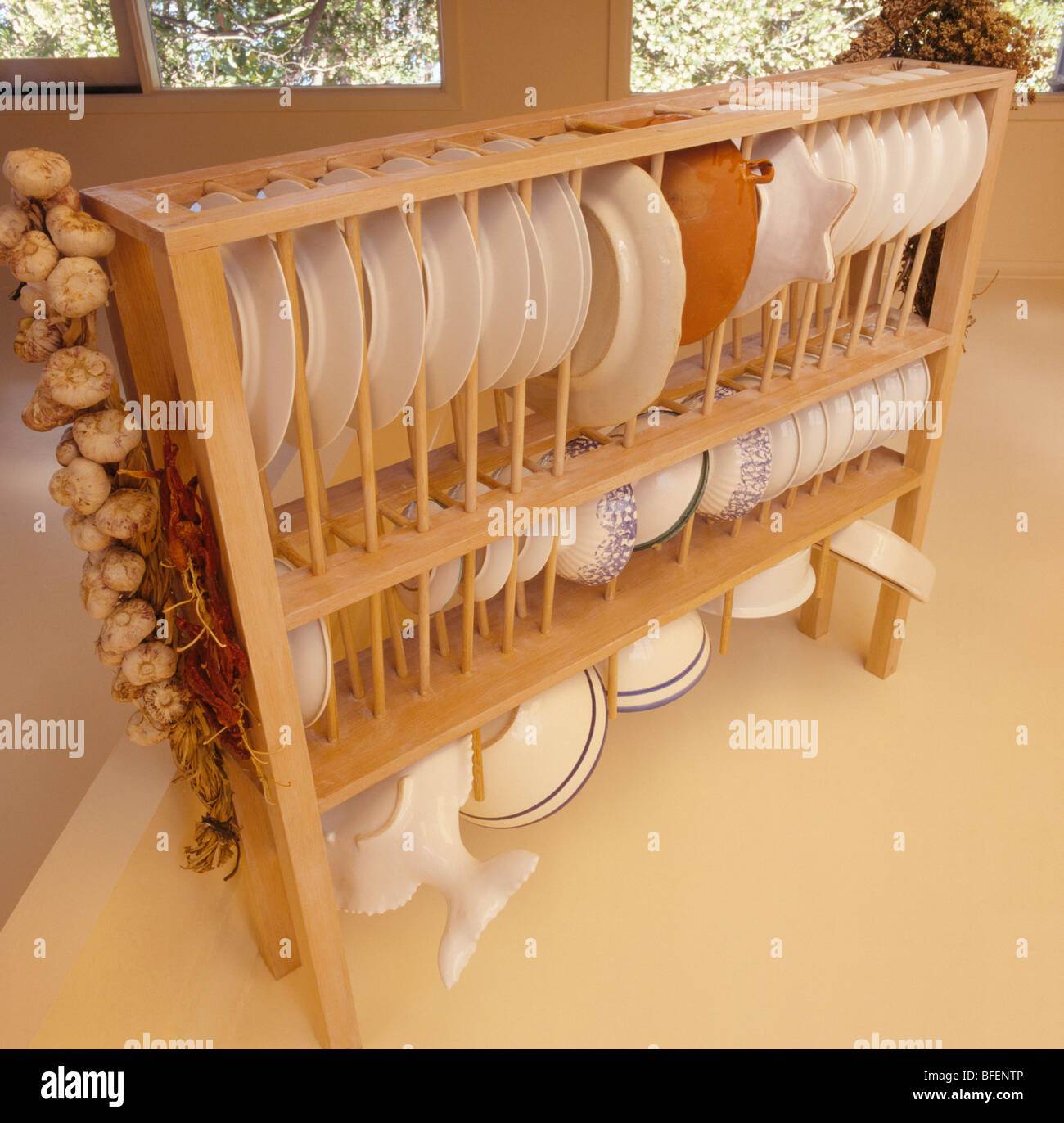 Closeup of white plates on suspended wooden platerack Stock Photo Alamy