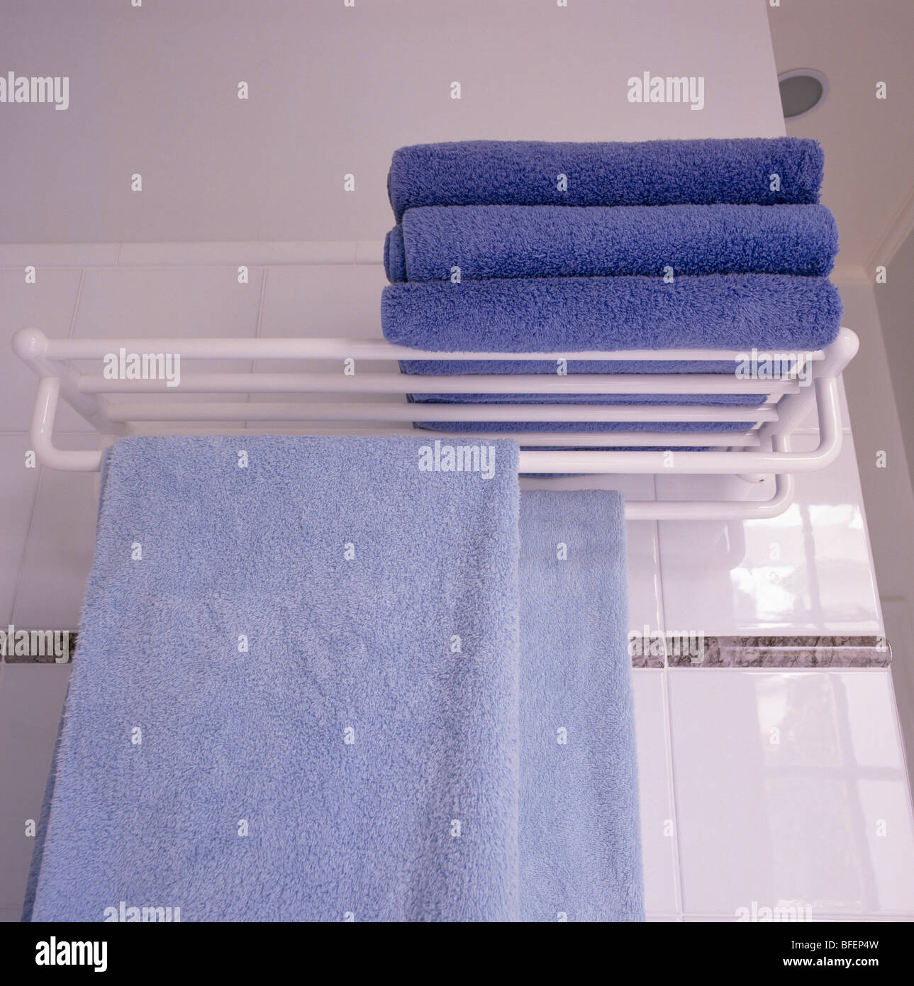 Close-up of blue towels on white storage rack in modern bathroom Stock Photo