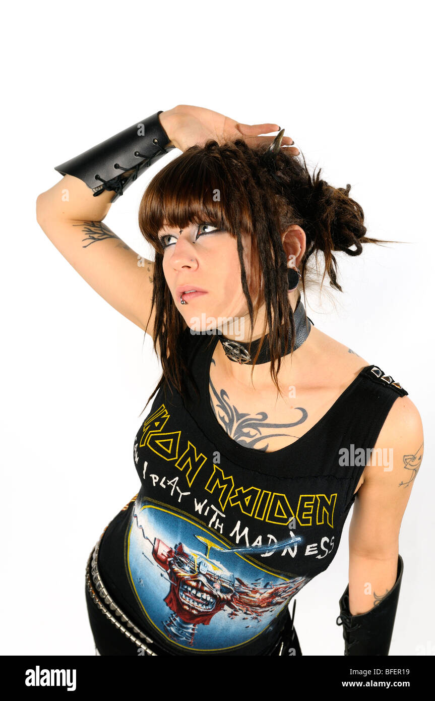 Young heavy metal lady punk with horns piercings and tattoos on a white  background Stock Photo - Alamy