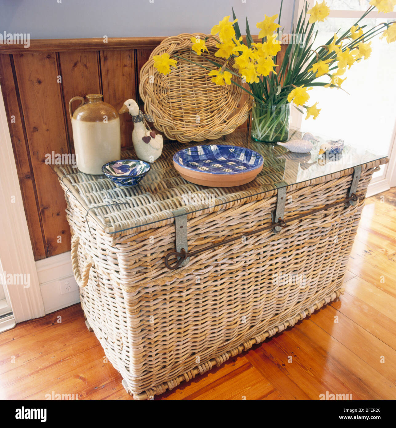 Blue Checked Bowls And Vase Of Daffodils On Large Wicker Chest