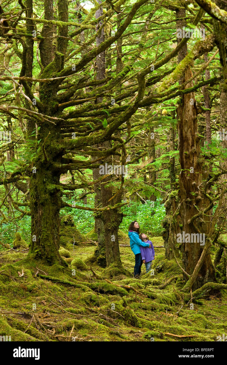 Mother and daughter in mossy forest, Naikoon Provincial Park, Queen Charlotte Islands, British Columbia, Canada Stock Photo