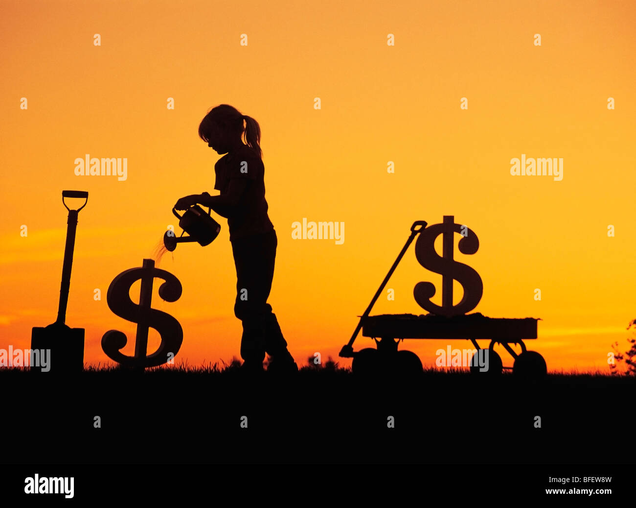 Conceptual of a young girl watering a newly planted dollar sign near Winnipeg, Manitoba, Canada Stock Photo