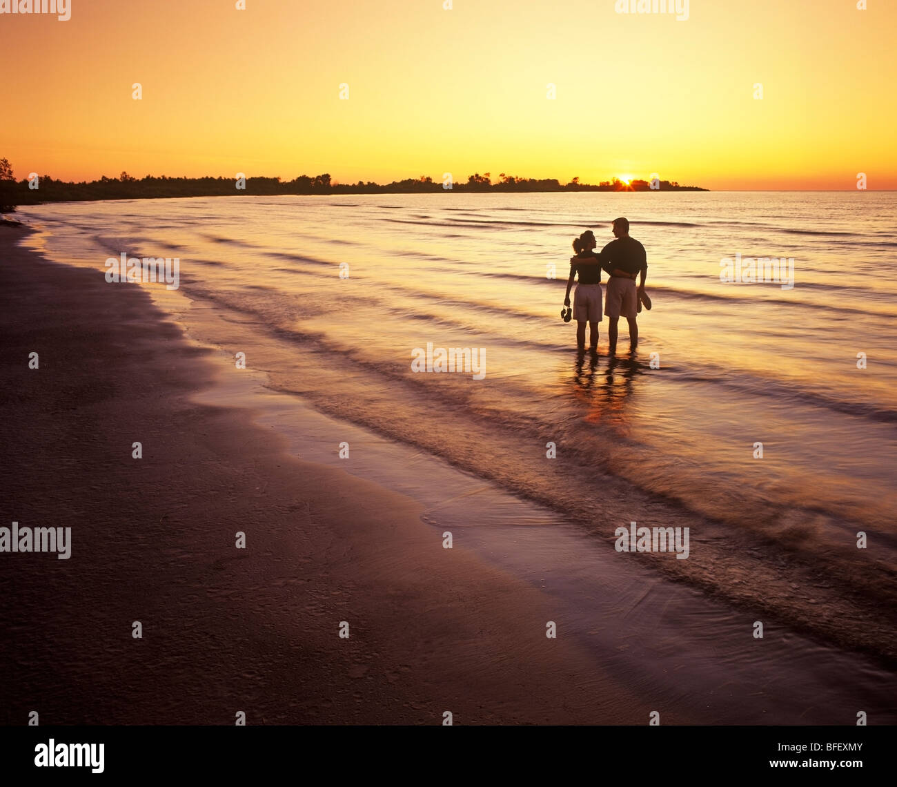 couple along beach at sunset, Patricia Beach Provincial Park, Lake
