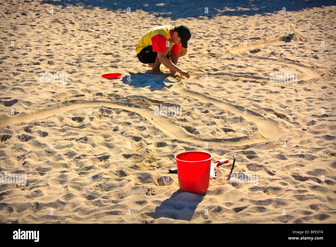Vacation resort employee preparing bucket and markers for a contest, sandy beach, Cuba Stock Photo