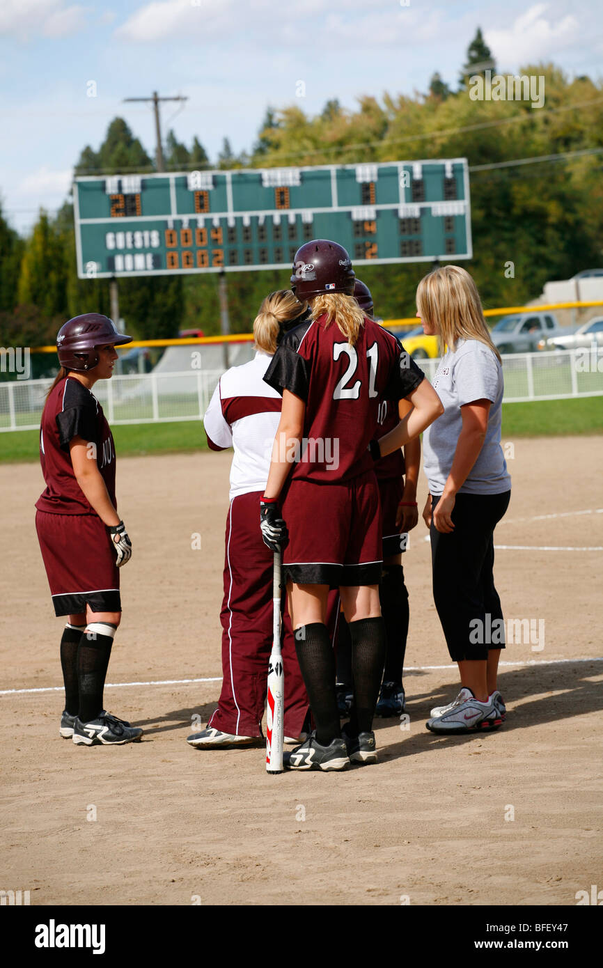 North Idaho College softball game, Sept. 28 2008, Coeur D Alene, Idaho. NIC huddles for a conference down the third base line. Stock Photo