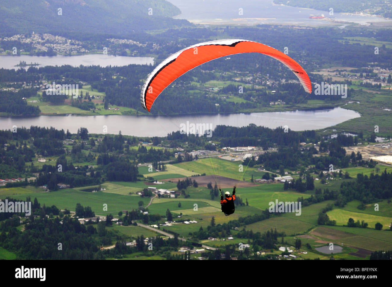 Paraglider sails from Mt. Prevost in Duncan, BC. Stock Photo