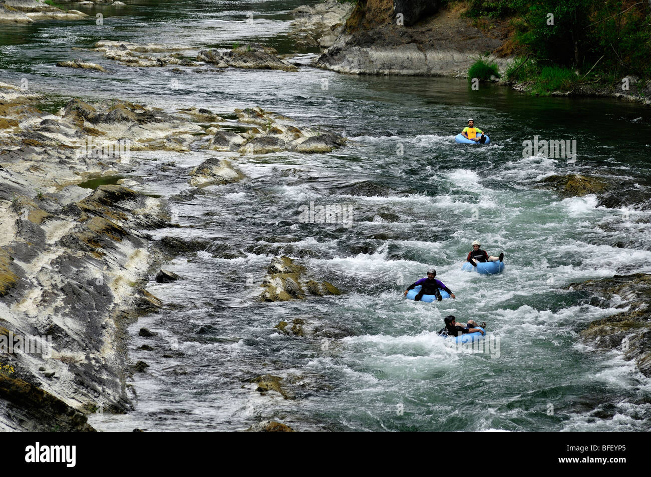 Four tubers going down the Cowichan river near Skutz Falls near Lake Cowichan. Stock Photo