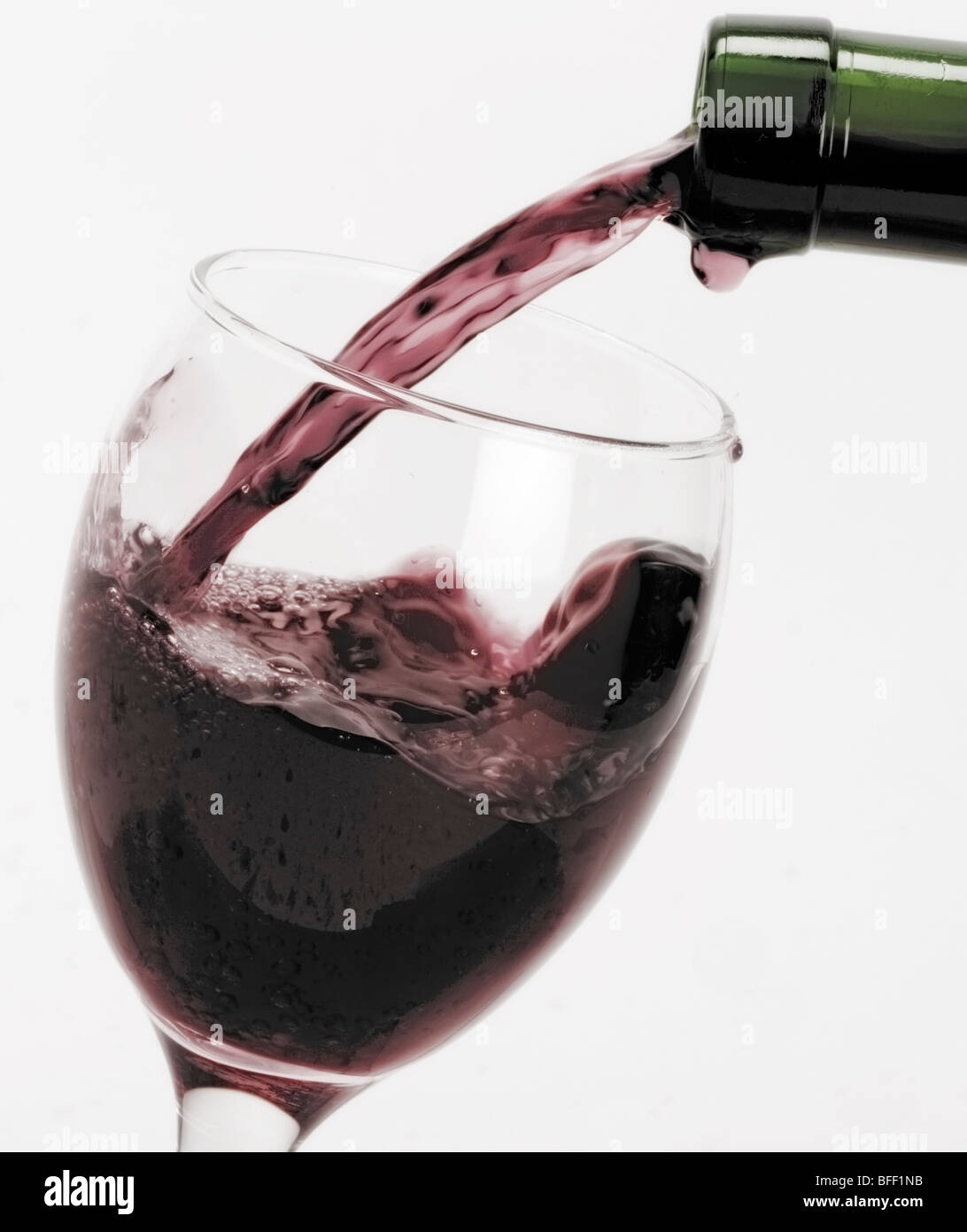 Red wine pouring into glass Stock Photo