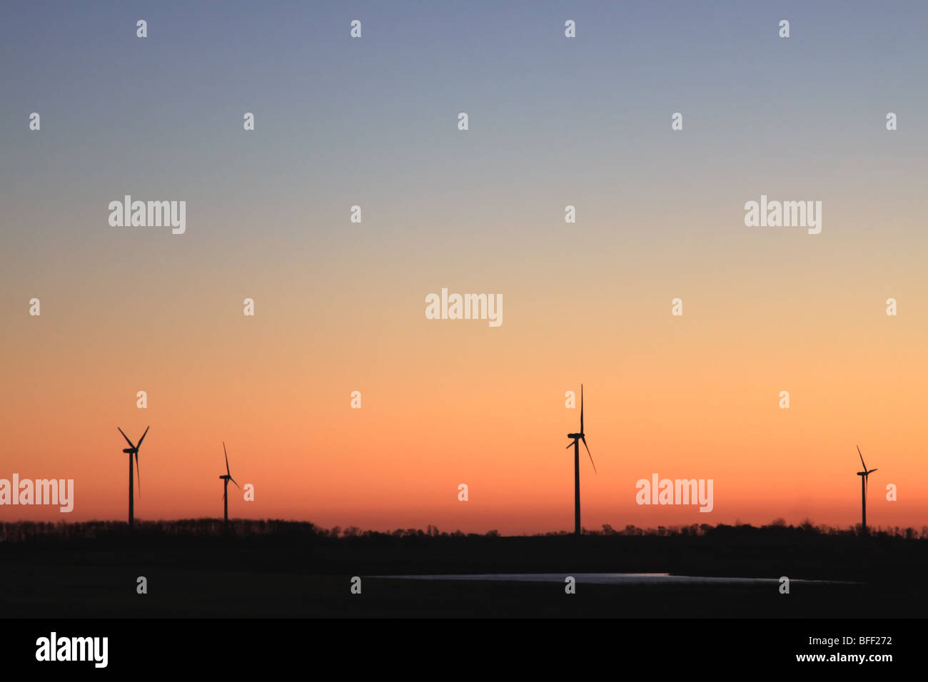 Wind Turbine Electrical Generators back lit by a beautiful sunrise in North Dakota Stock Photo