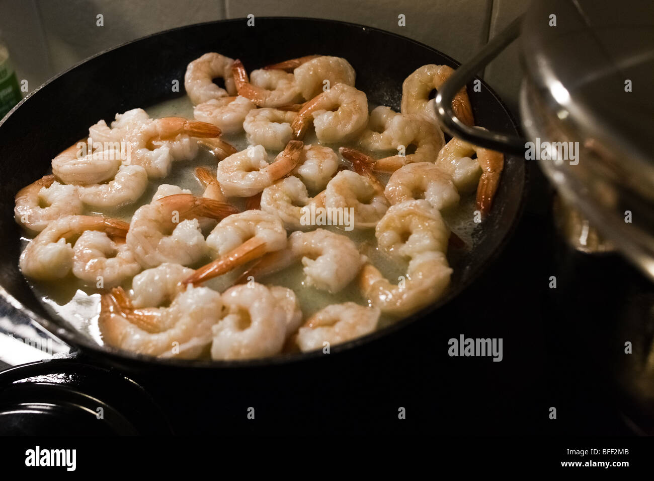 Frying Pink Shrimps in a Pan of Butter Stock Photo