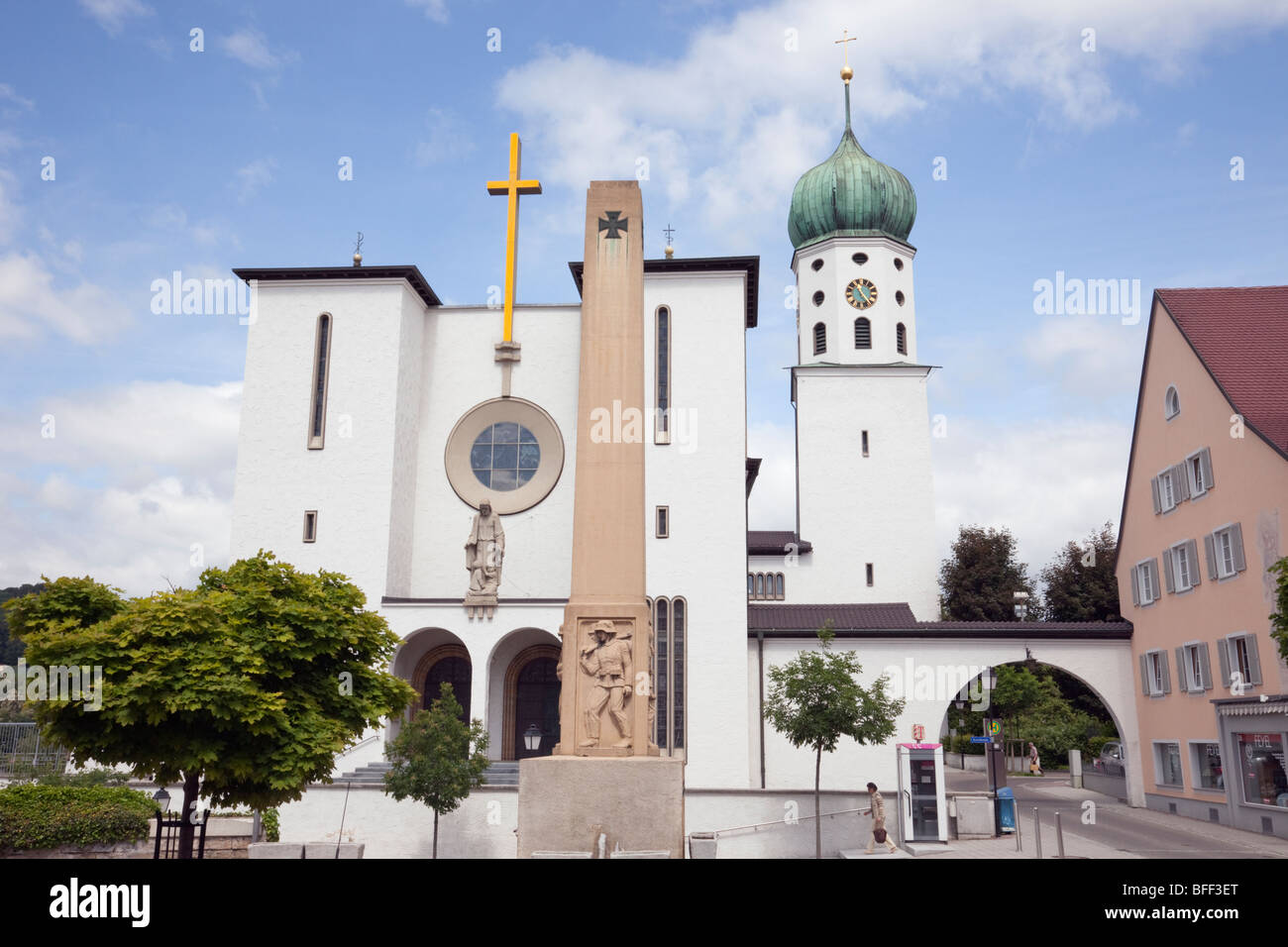 Stockach, Baden Wurttenburg, Germany, Europe. War memorial in front of large modern white church building in historic small town Stock Photo
