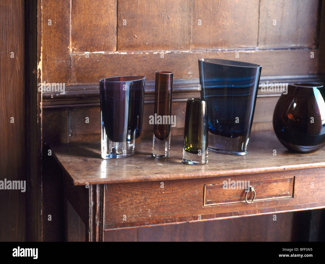 Close Up Of Collection Of Modern Lsa Brown Glass Vases On Antique