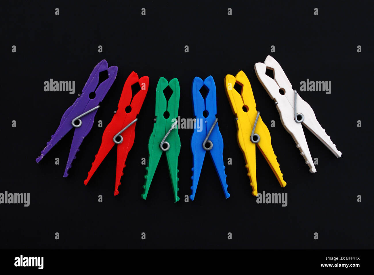 Multicolor laundry clips on black background Stock Photo