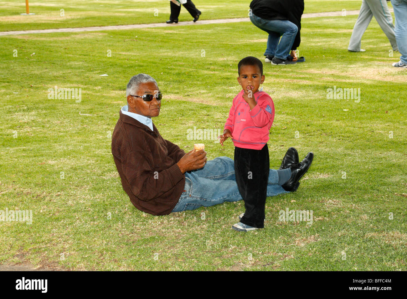 African Grandfather & grandson spending time on the field, Stellenbosch