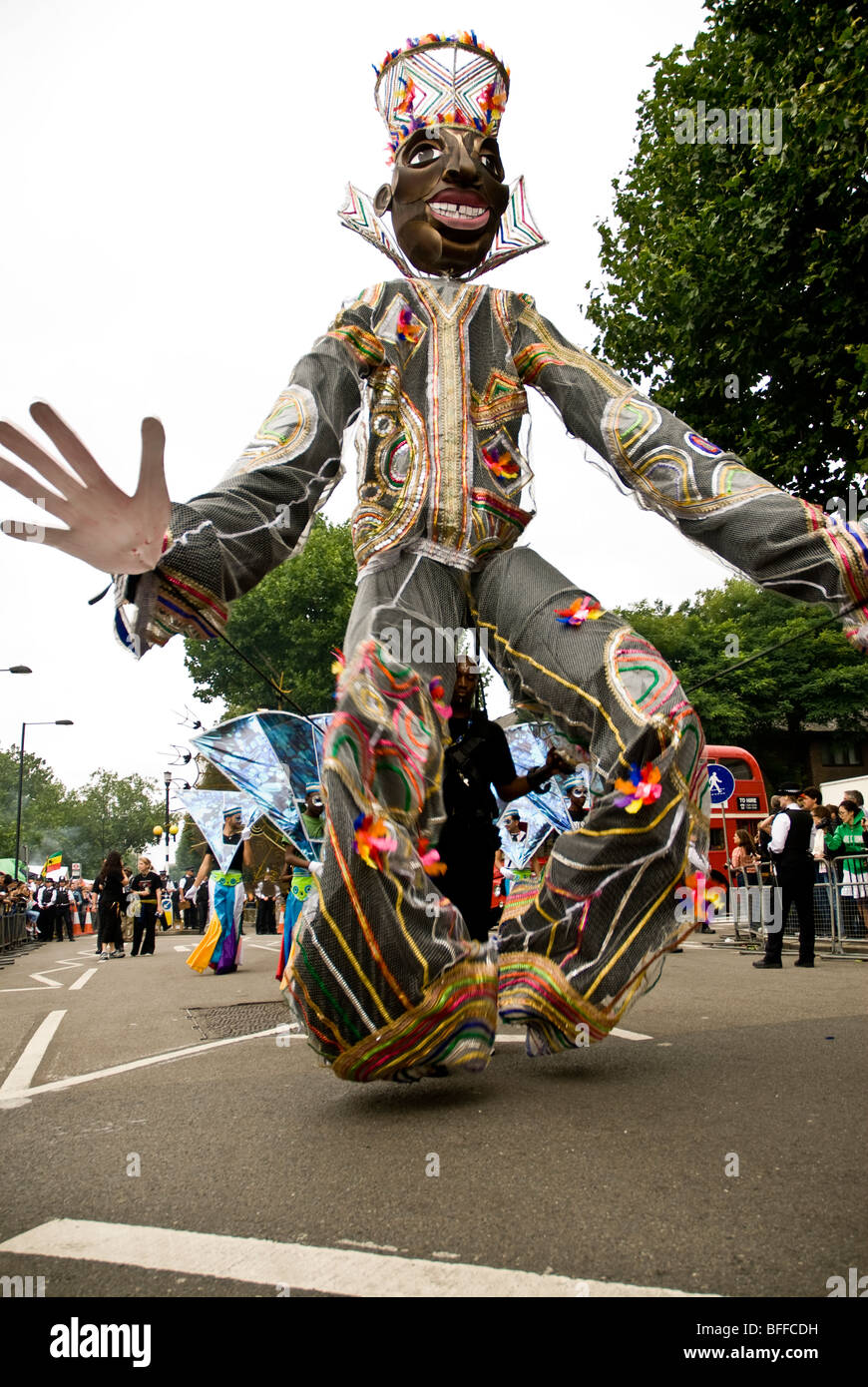 A tall man costume dancing in the parade at the Notting Hill carnival in London Stock Photo
