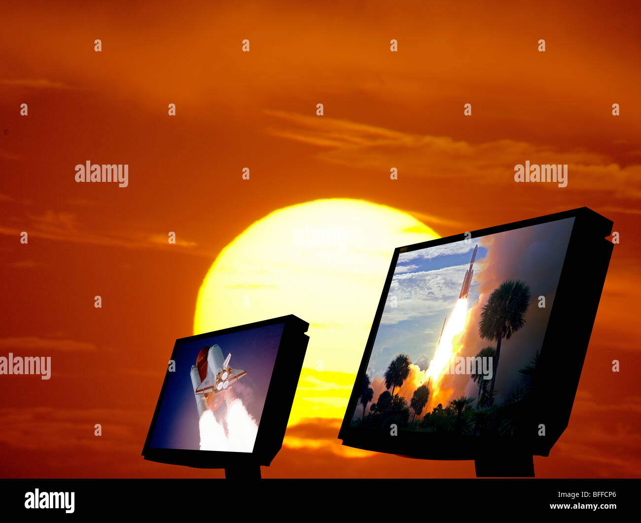 twin computer screens showing NASA shuttle launch images at sunset Stock Photo