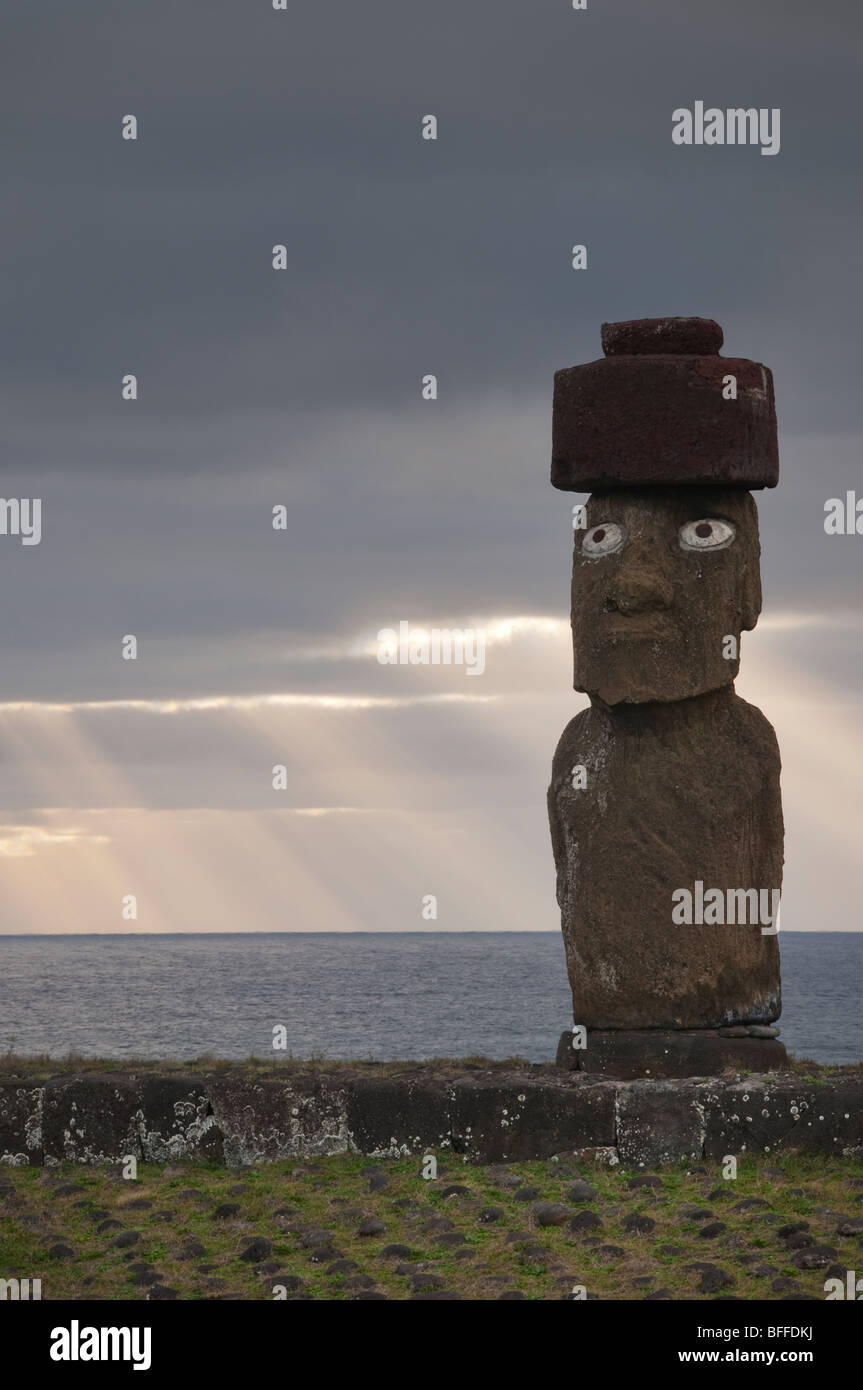 Easter Island Moai Statues at the Ahu Tahai site, with beams of light shining down in the stormy