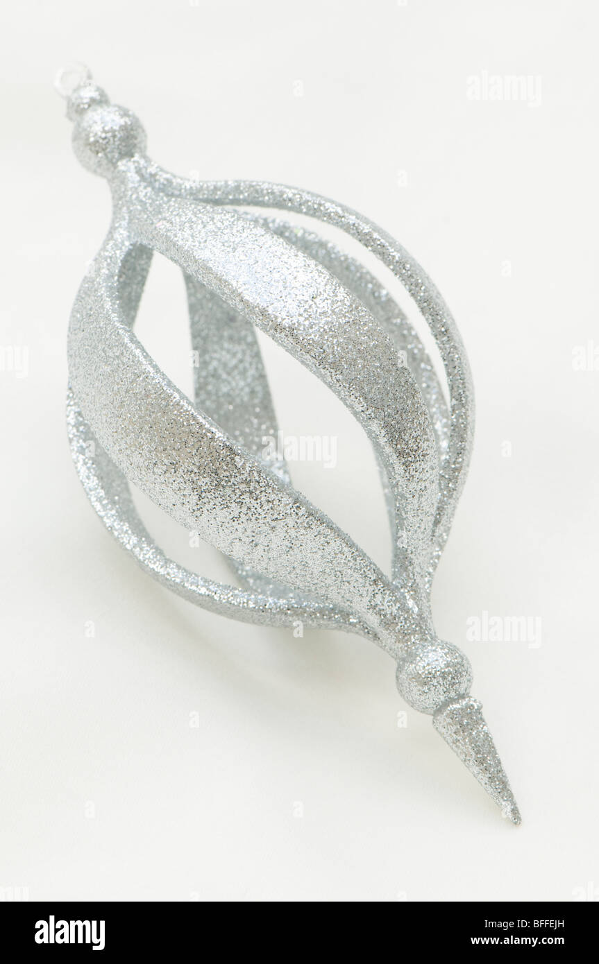 Silver glittery Christmas decoration against a creamy white background Stock Photo