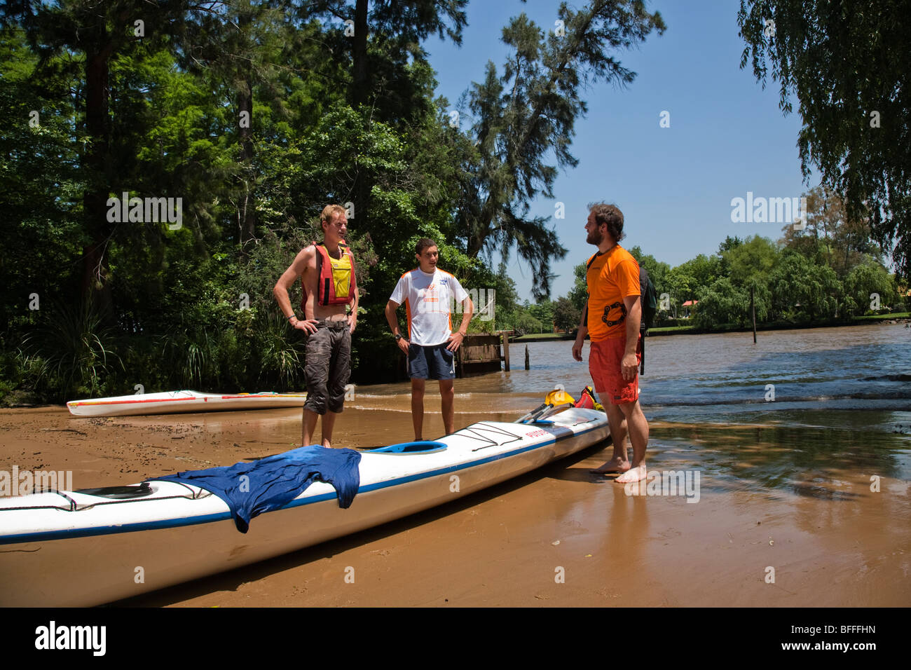 Kayakers pulling up at a beach in the Tigre Delta Stock Photo