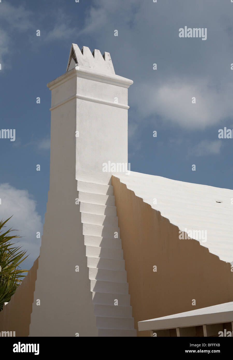 Classic Bermudan house with white chimney against a blue sky Stock Photo