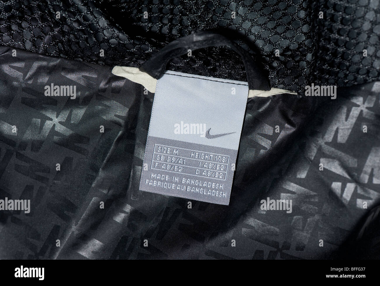 Nike windrunner clothing label in back of black mens rain jacket cagoule,  showing Nike tick logo Stock Photo - Alamy