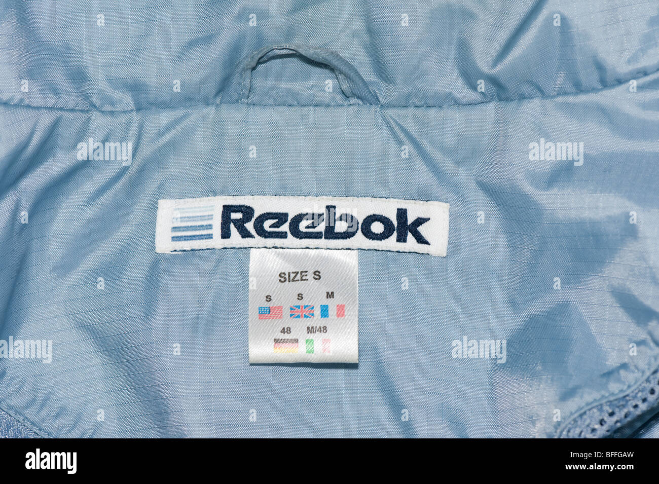 Reebok clothing label close up, mens overhead rain jacket cagoule Stock  Photo - Alamy