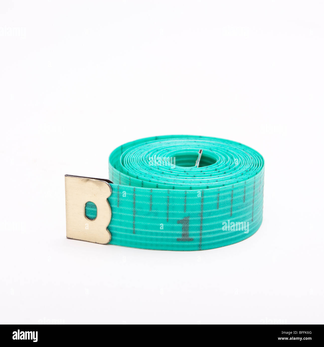 Dressmakers or Tailors rolled up tape measure isolated against white background. Stock Photo