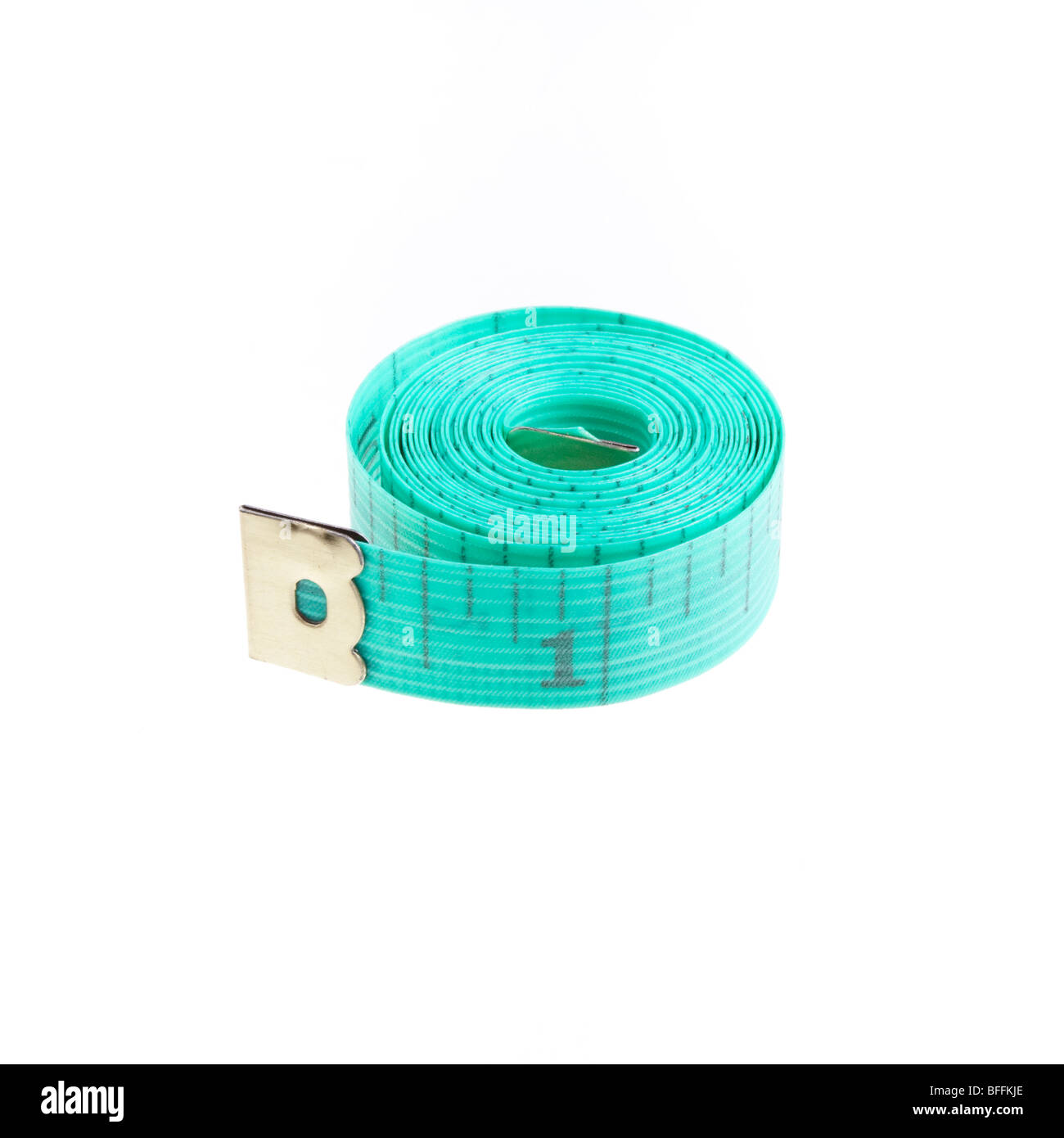 Dressmakers or Tailors rolled up tape measure isolated against white background. Stock Photo