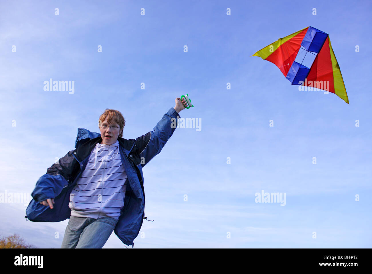teenage boy flying a kite Stock Photo