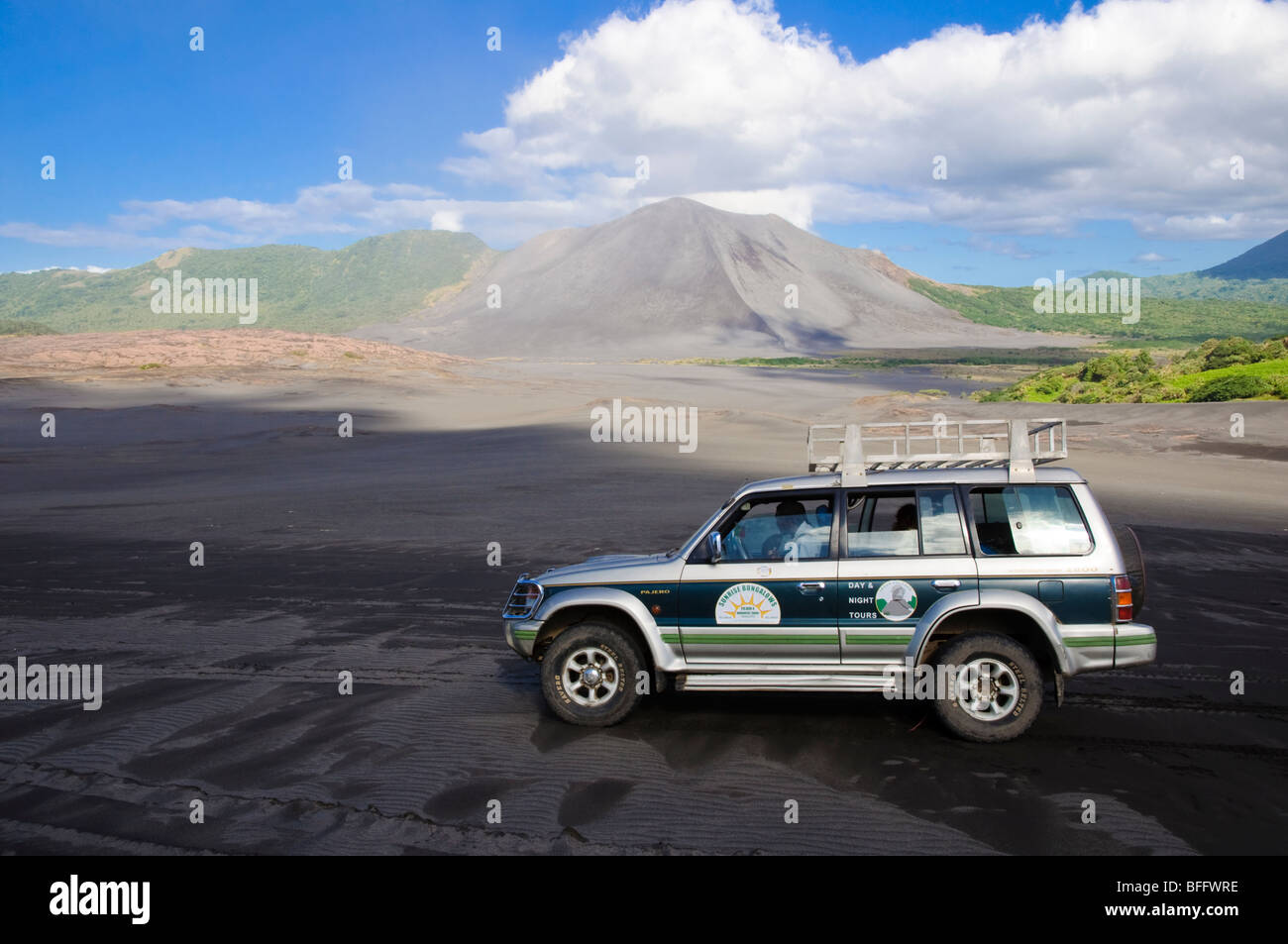 4WD vehicle in front of an active volcano. Click for details. Stock Photo