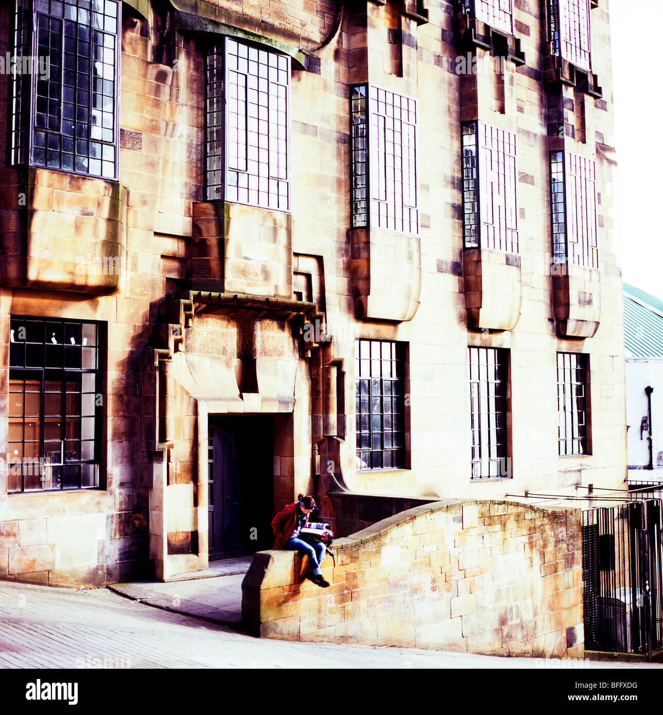 A girl reading a book outside the Glasgow School of Art building by Charles Renee MacIntosh Glasgow Scotland UK   KATHY DEWITT Stock Photo