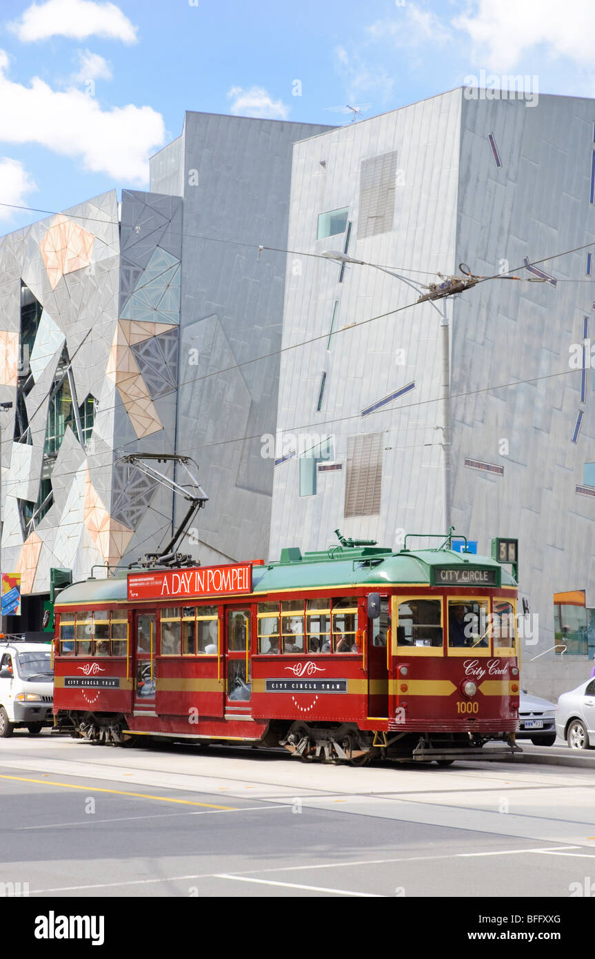 Traditional and modern symbols of Melbourne: old red City Circle heritage tram with Federation Square behind Stock Photo