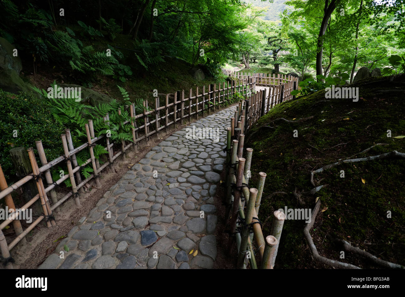 Cobbled path with bamboo fencing at Ritsurin Park. Stock Photo