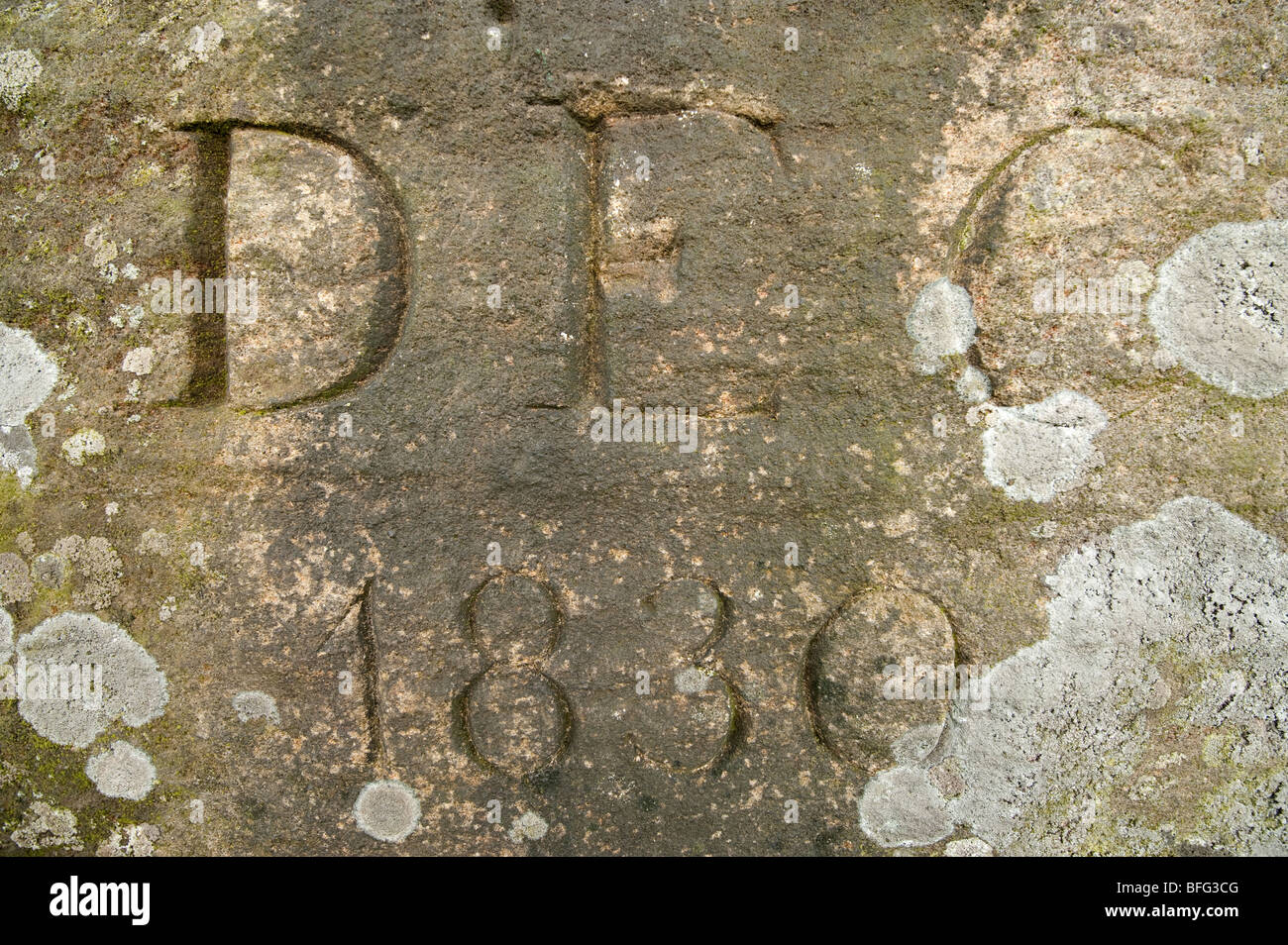 Old Gritstone rock with a date stamped December 1830 Stock Photo