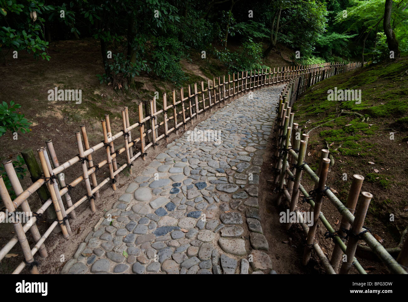 Cobbled path with bamboo fencing at Ritsurin Park. Stock Photo