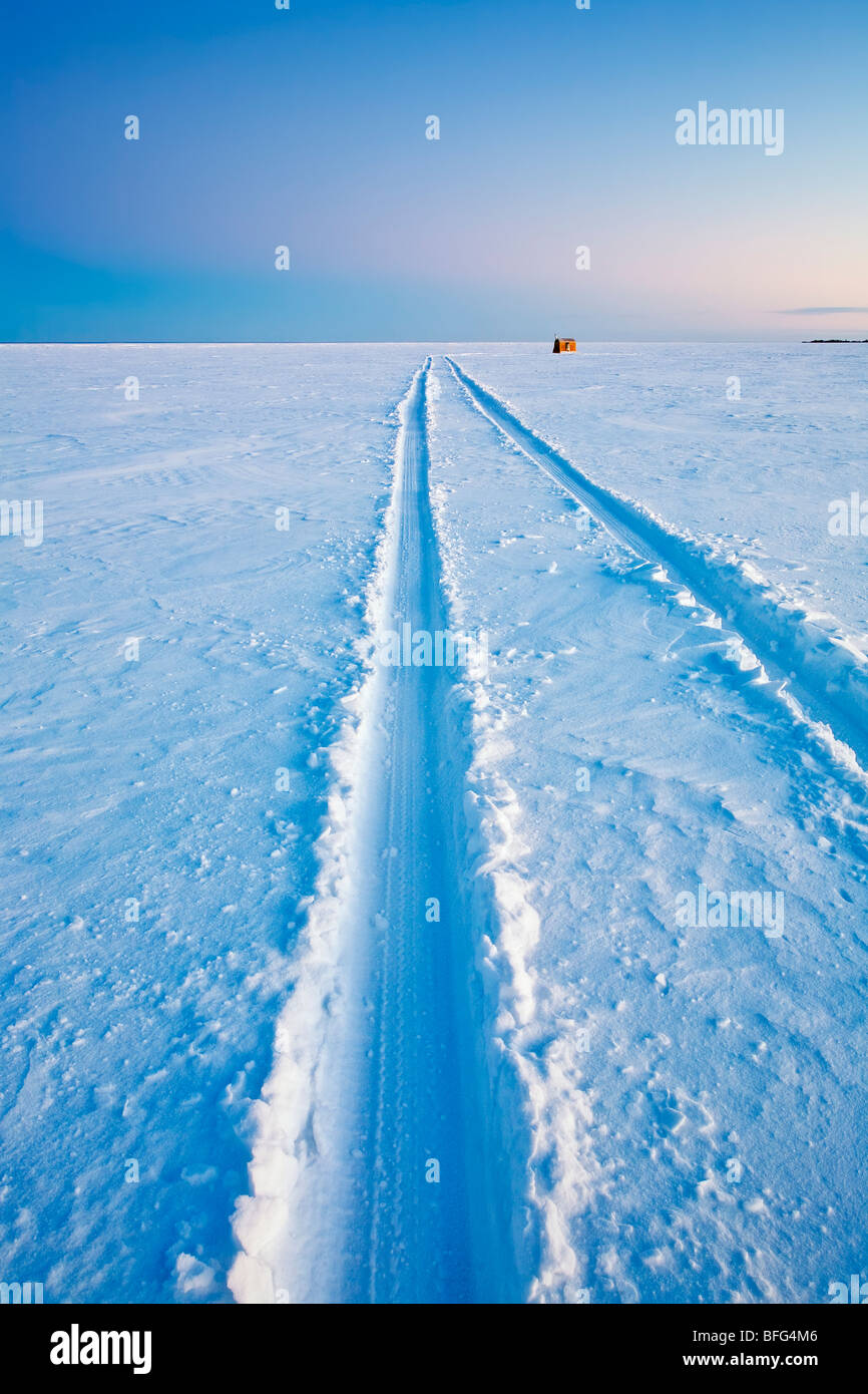 Vehicle tracks leading out to an Ice Fishing Shack on frozen Lake