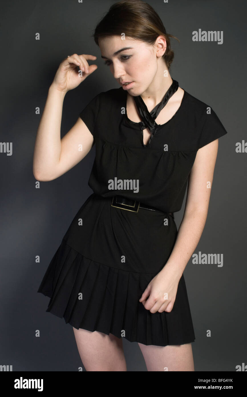 Fashion portrait of a young woman in a black dress Stock Photo - Alamy
