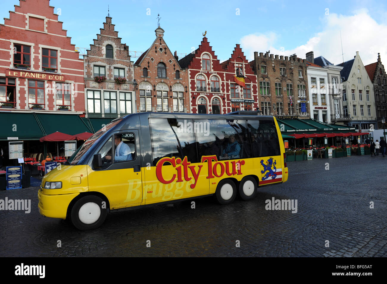 A City Tour bus for tourists sight seeing at Bruges in Belgium Europe Stock Photo