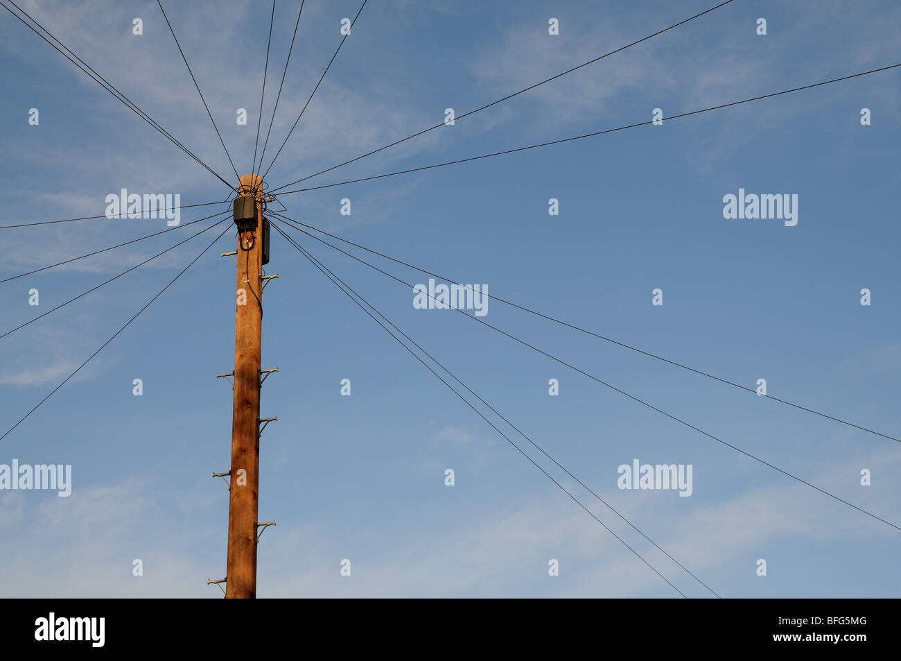 Telephone pole in the UK with lines running out radially Stock Photo