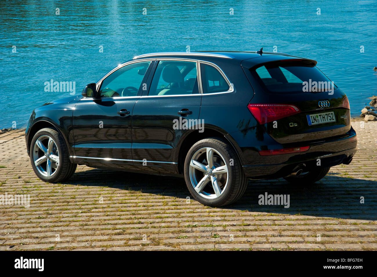 Audi Q5 in black rear and side view in front of Rhine River Stock Photo