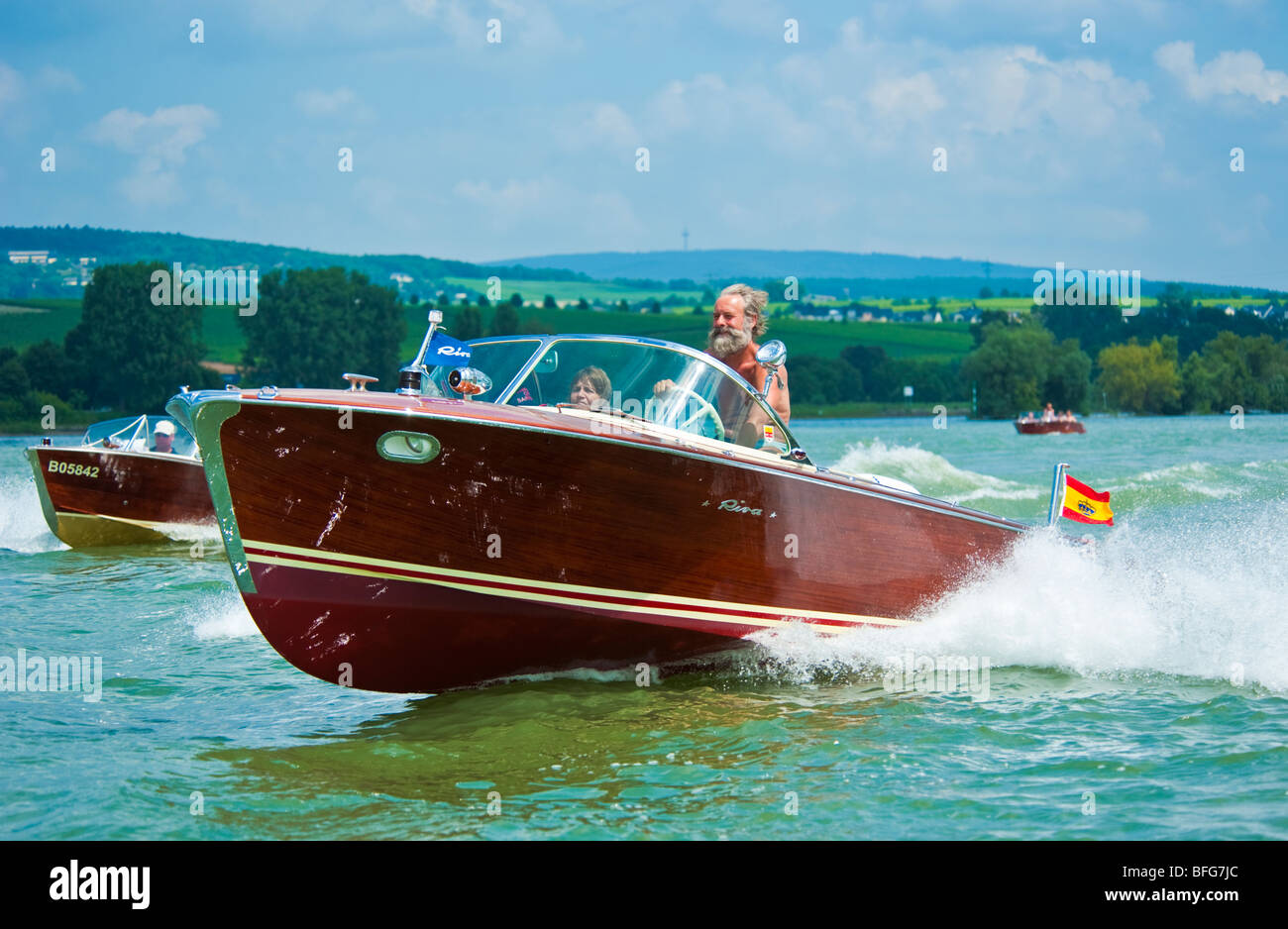 Classical wooden power boat Riva Super Florida driving with high speed on Rhine River Stock Photo