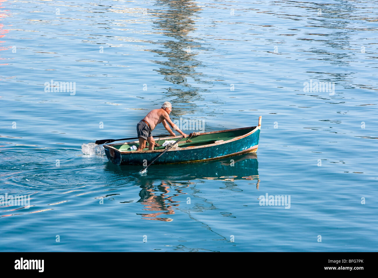 Man standing on small fishing boat hi-res stock photography and