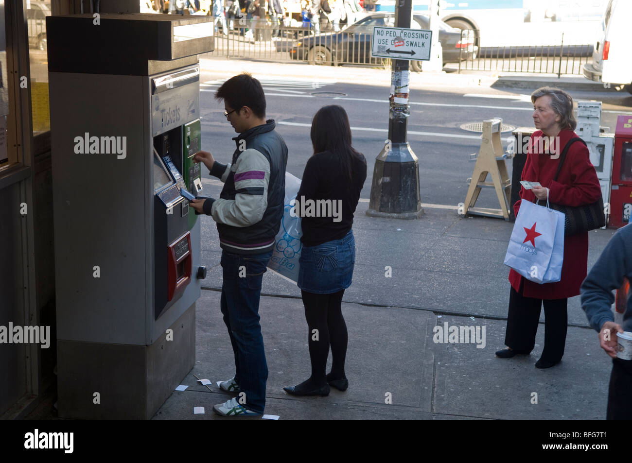 Passengers buy tickets for the Long Island Railroad from a vending machine in Flushing, Queens