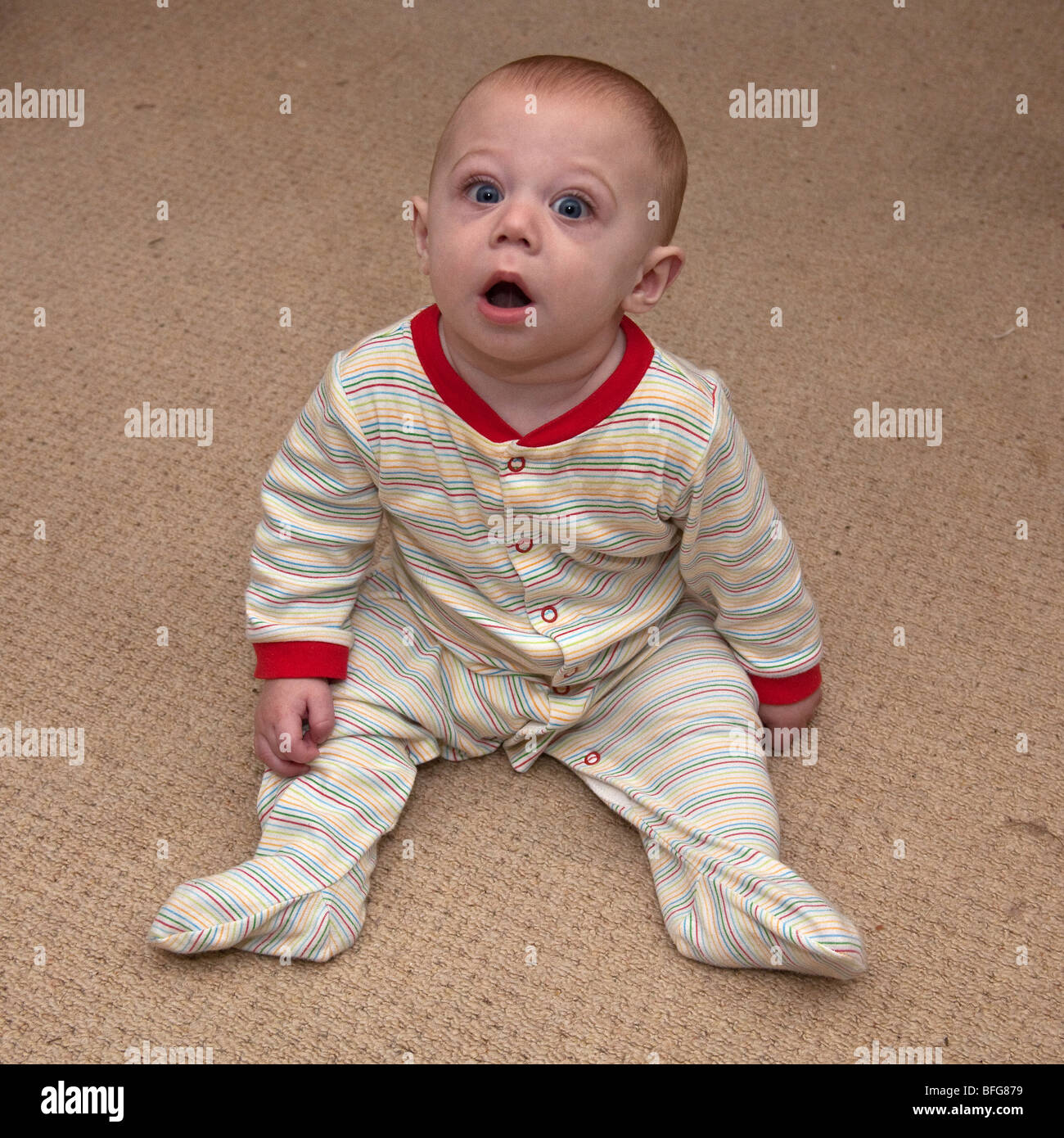 Six month old baby boy sitting on the floor , London, England Stock