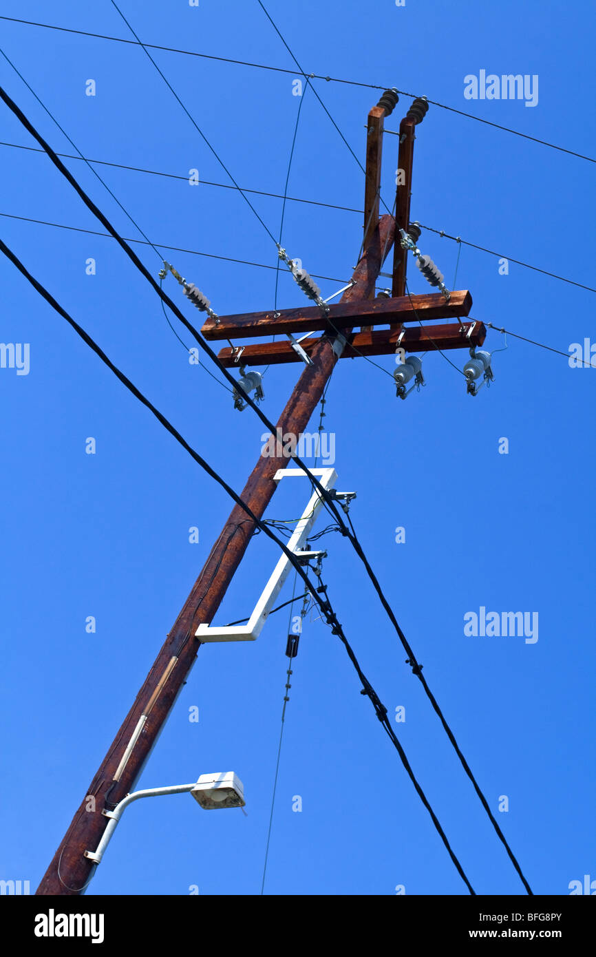 Close up view of telegraph pole with electricity and telephone cables ...